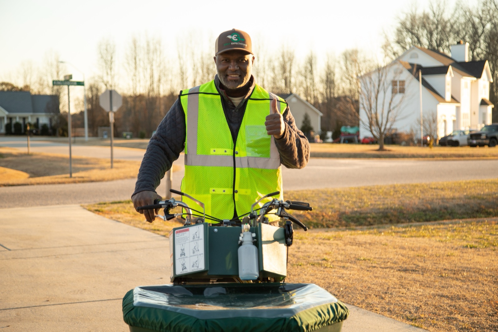 Owner Joe Brown out on a lawn at first light — the reason clients name him personally in their reviews, doing the work himself with his sons alongside.